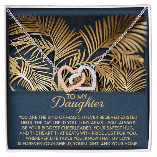 The Daughter-Your Home - Interlocking Hearts Necklace features cubic zirconia crystals and comes in a box with a gold fern design, containing a heartfelt "To My Daughter" message of love, support, and pride, making it an exceptional gift.