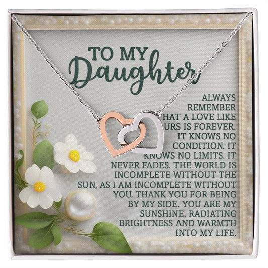 The Daughter-Love Forever - Interlocking Hearts Necklace in rose gold with cubic zirconia crystals rests on a card saying: "To my daughter, always remember that love like ours is forever... Thank you for being by my side. You are my sunshine, radiating brightness and warmth into my life.