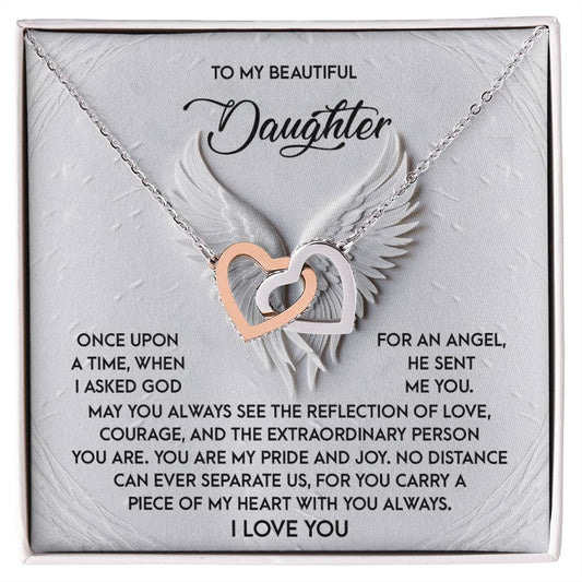 The Daughter-An Angel Interlocking Hearts Necklace features silver and rose gold heart pendants on a card with wings, expressing love, pride, and an eternal bond—a perfect gift for a cherished daughter.