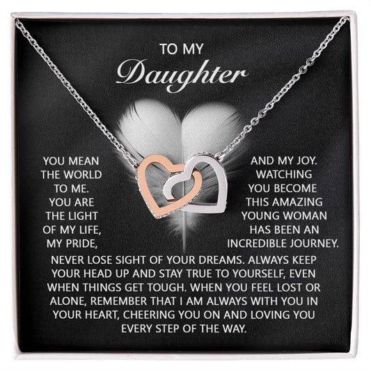The "Daughter-In Your Heart - Interlocking Hearts Necklace" features rose gold-finished pendants adorned with shimmering cubic zirconia crystals, beautifully complementing the heartfelt message from a parent to their daughter.