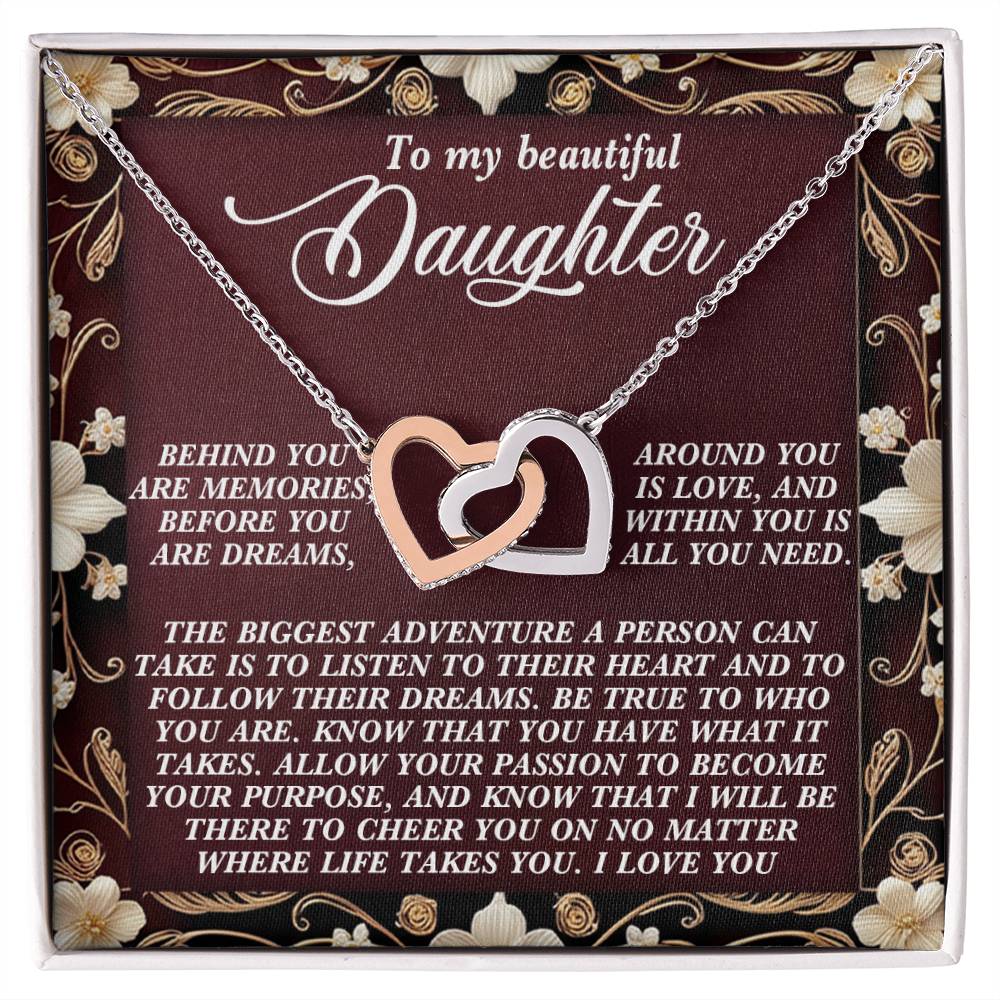 The Daughter-Follow Dreams Interlocking Hearts Necklace, featuring cubic zirconia crystals and a rose gold finish, comes on a floral card inscribed with: "To my beautiful daughter... Behind you are memories... Allow your passion to become your purpose... I love you.