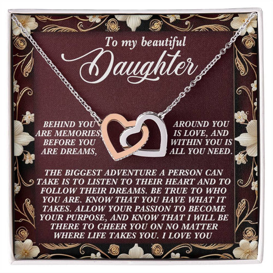 The Daughter-Follow Dreams Interlocking Hearts Necklace, featuring cubic zirconia crystals and a rose gold finish, comes on a floral card inscribed with: "To my beautiful daughter... Behind you are memories... Allow your passion to become your purpose... I love you.