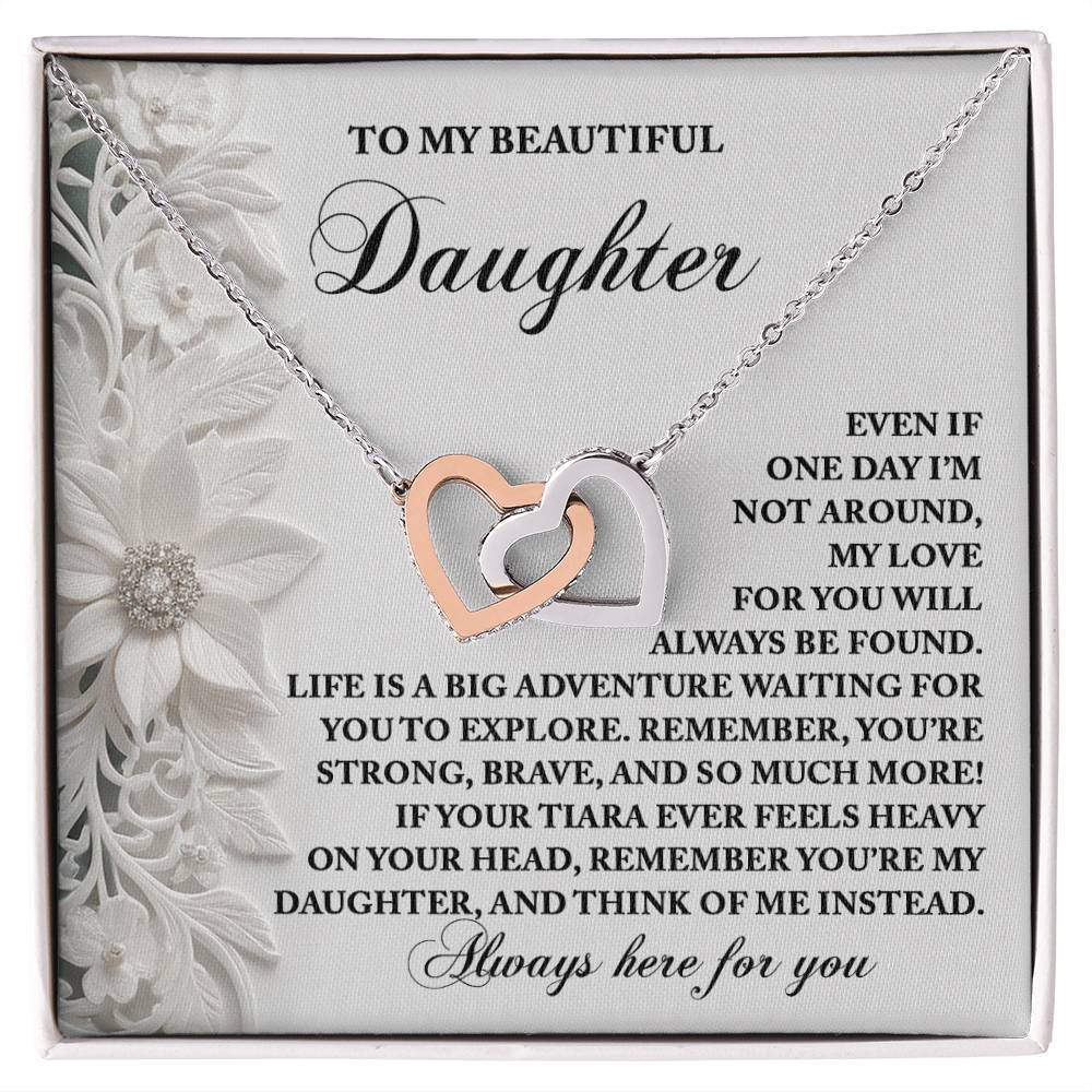 The Daughter-Think Of Me - Interlocking Hearts Necklace on a decorative card, with a rose gold finish and sparkling cubic zirconia crystals, conveys a heartfelt message to your daughter, celebrating love, support, and life's exciting adventures.