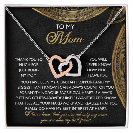 The Mom-Best Friend - Interlocking Hearts Necklace includes cubic zirconia crystals on silver and rose gold pendants, presented in a gift box with a heartfelt message expressing gratitude, love, and appreciation for a mother's unwavering support and sacrifices.