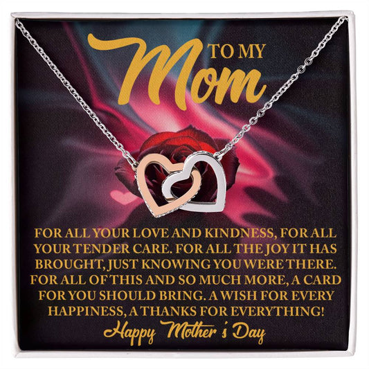 The Mom-Tender Care - Interlocking Hearts Necklace comes on a card with a heartfelt Mother's Day message, featuring a rose gold background, gratitude text overlay, and elegant "Happy Mother's Day" script accented by cubic zirconia crystals.