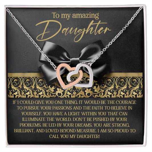 The Daughter-Pursue Passions Interlocking Hearts Necklace features rose gold and silver heart pendants. It is showcased on a card reading "To my amazing daughter," offering pride and encouragement against an elegant black background adorned with a bow.