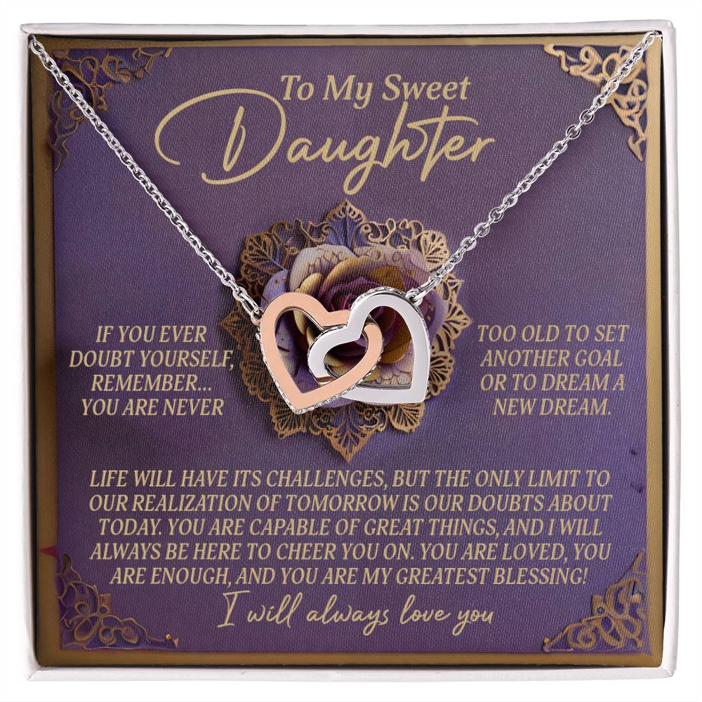 The Daughter-Greatest Blessing Interlocking Hearts Necklace, with a rose gold finish and cubic zirconia crystals, is elegantly displayed on a card that reads "To My Sweet Daughter," celebrating her strength and love as a true blessing.