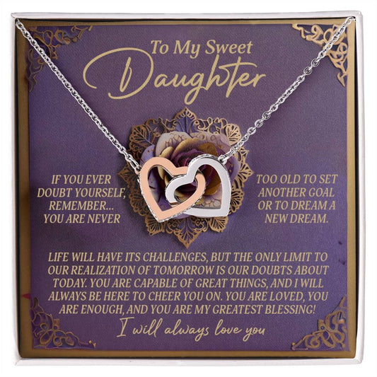 The Daughter-Greatest Blessing Interlocking Hearts Necklace, with a rose gold finish and cubic zirconia crystals, is elegantly displayed on a card that reads "To My Sweet Daughter," celebrating her strength and love as a true blessing.