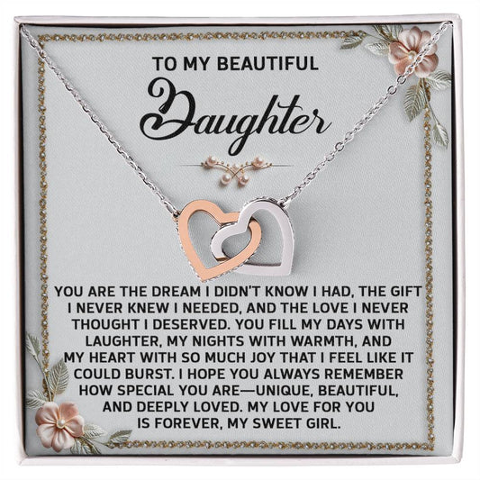 The Daughter-My Sweet Girl - Interlocking Hearts Necklace features pendants embellished with cubic zirconia, presented on a card with a heartfelt message for a daughter and floral corner details.
