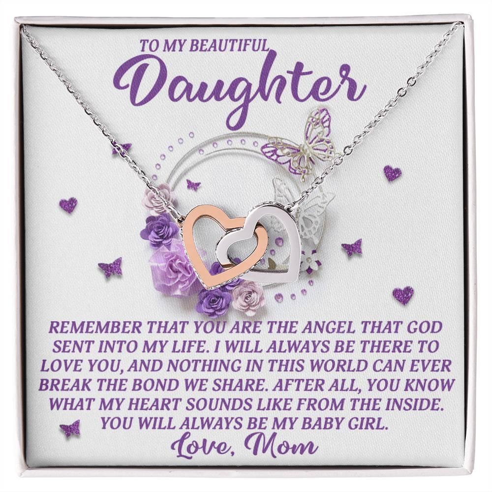 The Daughter-Angel Heart gift box includes an Interlocking Hearts necklace with intertwined heart pendants in a rose gold finish. It features text: "To my beautiful daughter. Remember you are the angel that God sent into my life... Love, Mom," adorned with purple roses, hearts, and a butterfly.