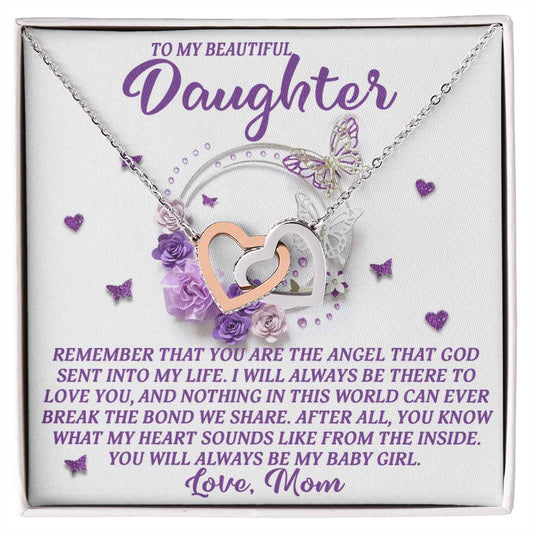 The Daughter-Angel Heart gift box includes an Interlocking Hearts necklace with intertwined heart pendants in a rose gold finish. It features text: "To my beautiful daughter. Remember you are the angel that God sent into my life... Love, Mom," adorned with purple roses, hearts, and a butterfly.