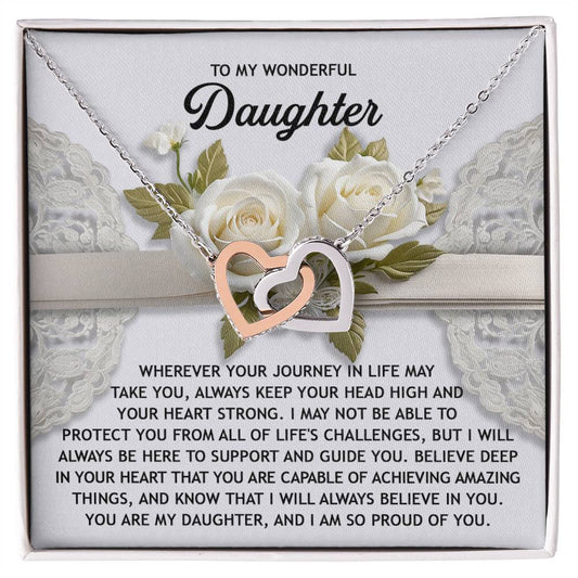 The Daughter-Your Heart - Interlocking Hearts Necklace, featuring a rose gold finish and sparkling cubic zirconia crystals, sits on a white gift box surrounded by roses, inspiring confidence and self-belief with its heartfelt message for daughters.