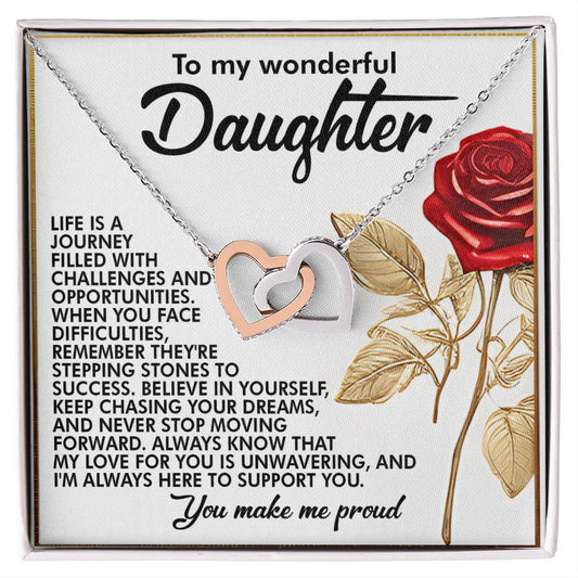 The Daughter-Journey Challenges - Interlocking Hearts Necklace features intertwined rose gold and silver hearts adorned with cubic zirconia crystals. It comes with a card encouraging a daughter to persevere and believe in her dreams, ending lovingly with "You make me proud," alongside a red rose illustration.