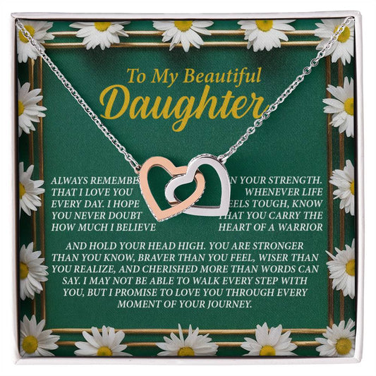 The Daughter-Your Journey - Interlocking Hearts Necklace, featuring a rose gold finish with sparkling cubic zirconia crystals, is displayed on a green card with daisies that reads: "To My Beautiful Daughter," offering loving support and encouragement.