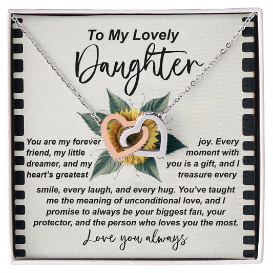 The Daughter-Little Dreamer Interlocking Hearts Necklace in rose gold with cubic zirconia crystals is placed against a heartfelt message board for a daughter, expressing love, joy, dreams, and support. A sunflower image enhances this tender sentiment.