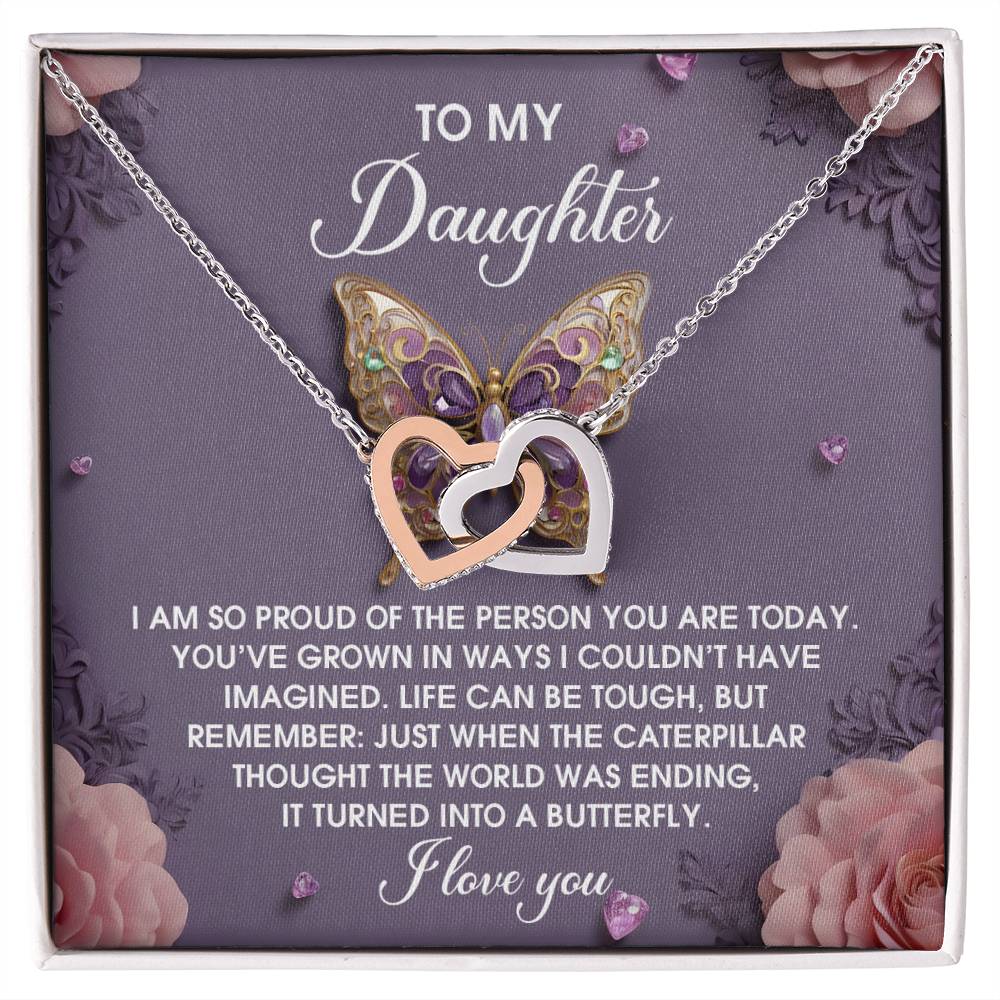 The "Daughter-A Butterfly - Interlocking Hearts Necklace" features a rose gold finish with heart pendants, cubic zirconia embellishments, and is displayed on a card with a butterfly design and heartfelt message.