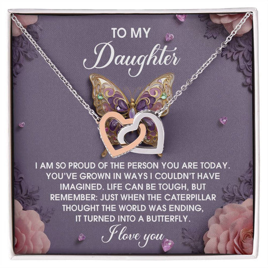 The "Daughter-A Butterfly - Interlocking Hearts Necklace" features a rose gold finish with heart pendants, cubic zirconia embellishments, and is displayed on a card with a butterfly design and heartfelt message.