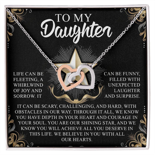 The Daughter-Shining Star gift box includes an Interlocking Hearts necklace with cubic zirconia crystals. It features heartfelt messages of love, joy, courage, and support for a daughter amidst life's challenges, beautifully framed with decorative gold patterns.