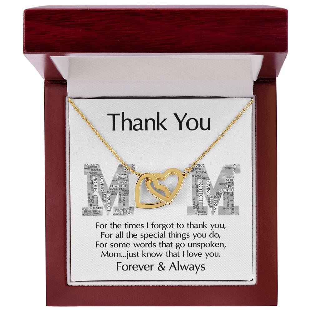 The "To Mom, Thank You - Interlocking Hearts Necklace," adorned with cubic zirconia crystals, is elegantly presented in an open wooden box with a heartfelt engraved message, making it the perfect personalized gift for expressing gratitude to a mother.