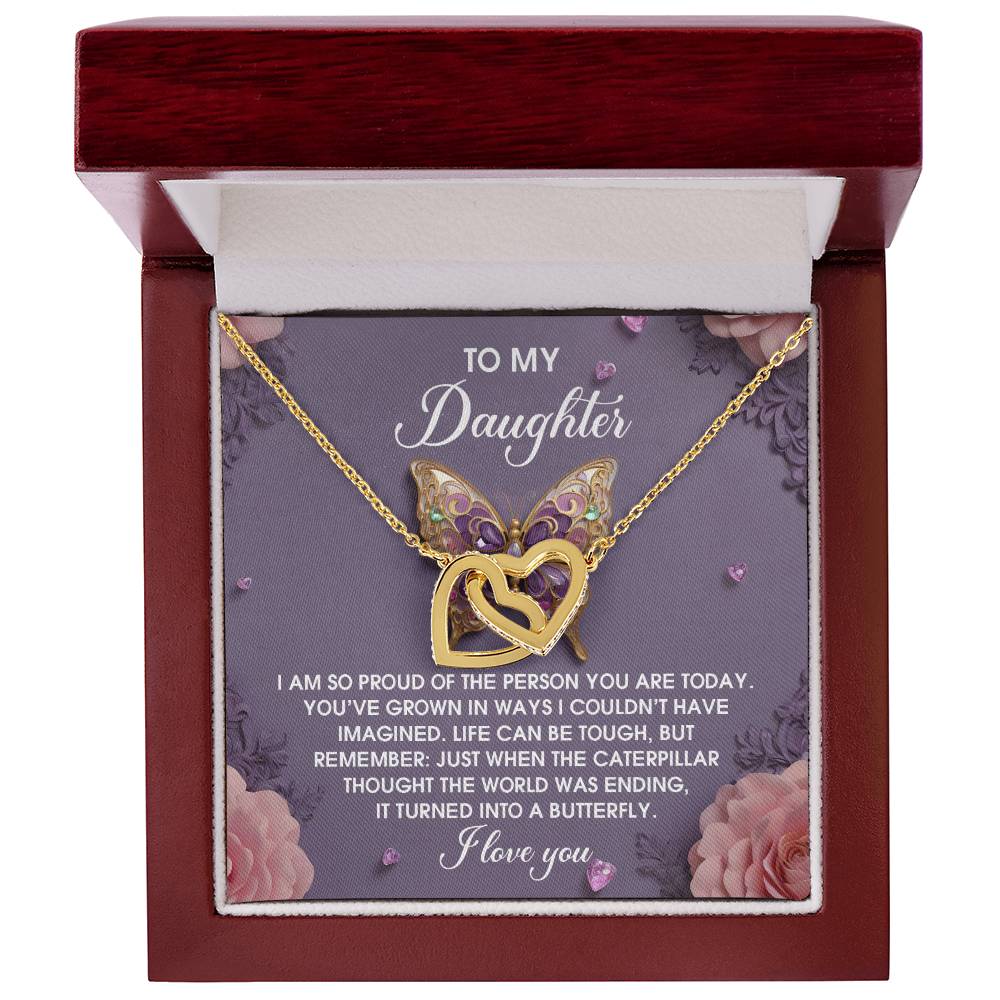 The jewelry box reveals the "Daughter-A Butterfly - Interlocking Hearts Necklace" with butterfly wings, a rose gold finish, and shimmering cubic zirconia crystals, complemented by a heartfelt message for a beloved daughter.