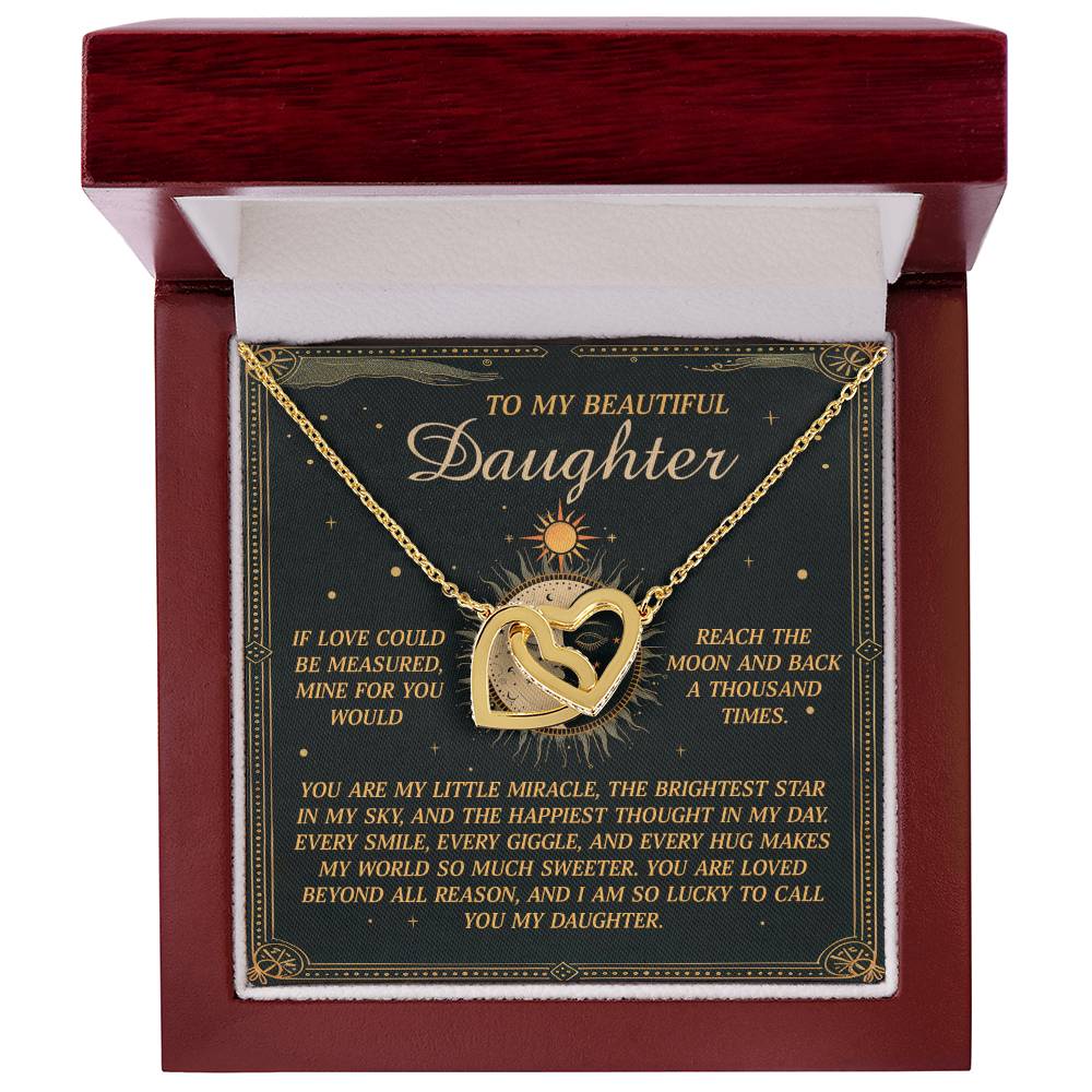 The Daughter-To Call You - Interlocking Hearts Necklace, featuring cubic zirconia crystals and a rose gold finish, is set in a red velvet-lined box. The inside lid has a heartfelt message to a daughter, expressing endless love with gold accents and floral borders.