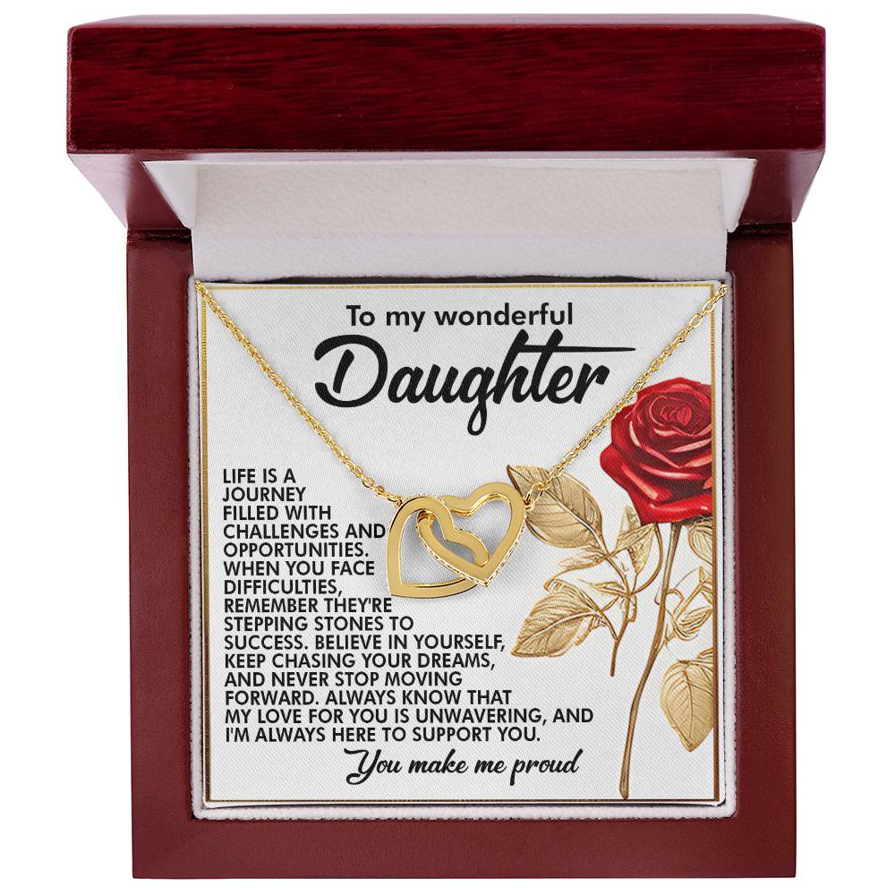 The Daughter-Journey Challenges Interlocking Hearts Necklace, in rose gold and housed in a wooden box featuring a red rose illustration and an inspirational message, encourages daughters to overcome challenges and pursue dreams, symbolizing unwavering support.