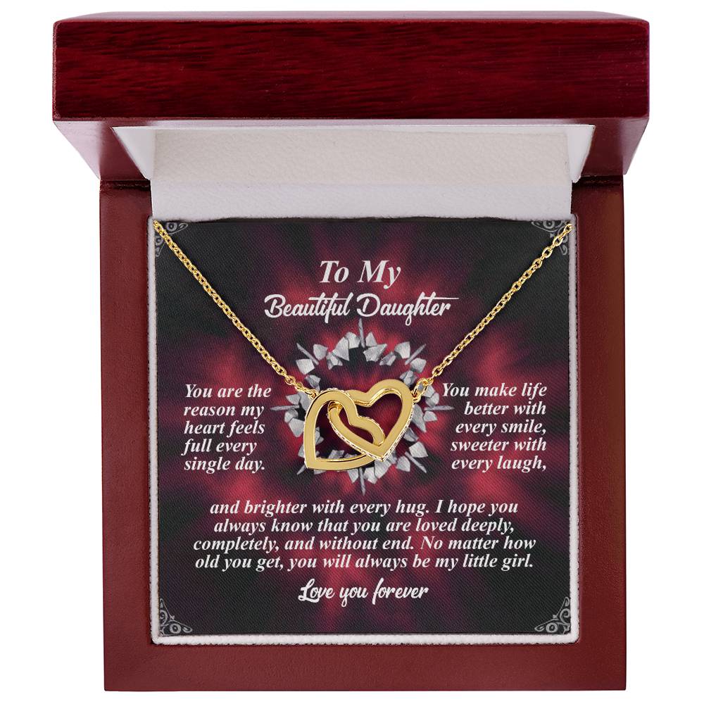 The Daughter-Every Hug - Interlocking Hearts Necklace in rose gold finish, adorned with sparkling cubic zirconia crystals, is showcased in an open wooden box. A heartfelt message card inside celebrates a daughter's importance and their enduring bond.