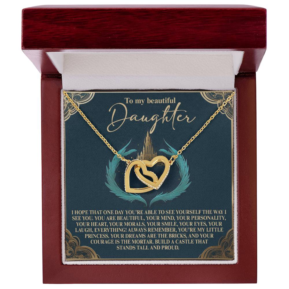 This exquisite Daughter-Little Princess Interlocking Hearts necklace features intertwined gold pendants with a rose gold finish and shimmering cubic zirconia crystals. The jewelry box lid includes a heartfelt message to a daughter, celebrating her beauty, mind, and dreams.