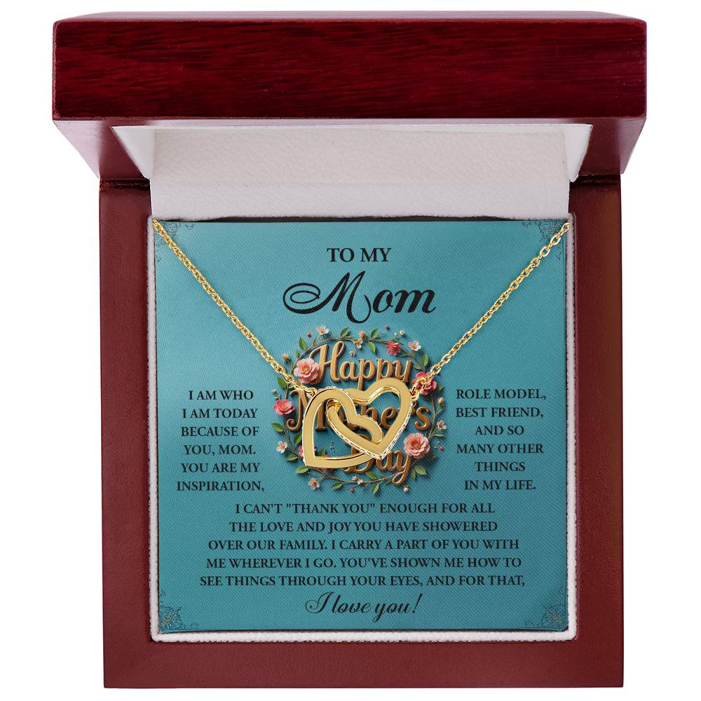 The Mom-Our Family Interlocking Hearts Necklace features a rose gold finish, with "Happy" engraved on it. Adorned with sparkling cubic zirconia crystals, it comes in a red box with a heartfelt message to mom and floral patterns.