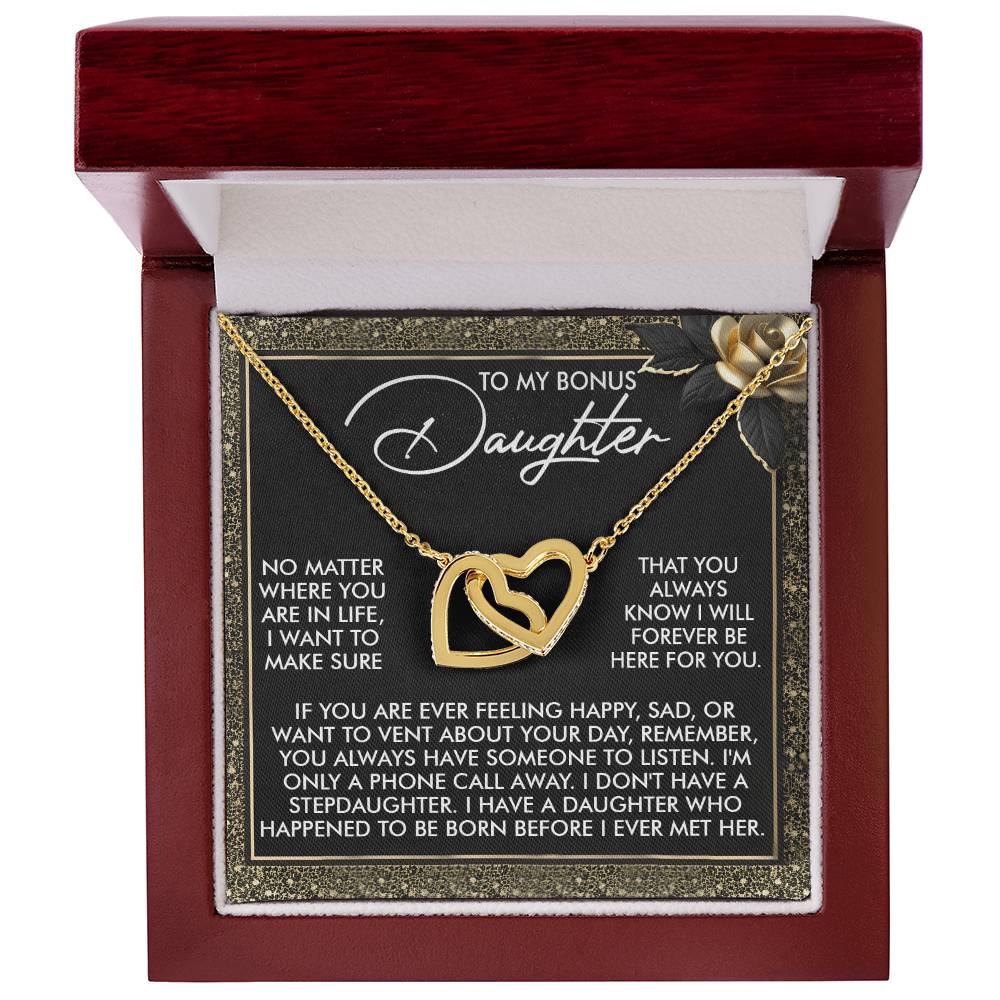 A jewelry box with the "Daughter-Phone Call - Interlocking Hearts Necklace," featuring shimmering cubic zirconia crystals. The lid holds a heartfelt message for a "bonus daughter," expressing love, support, and unwavering presence.