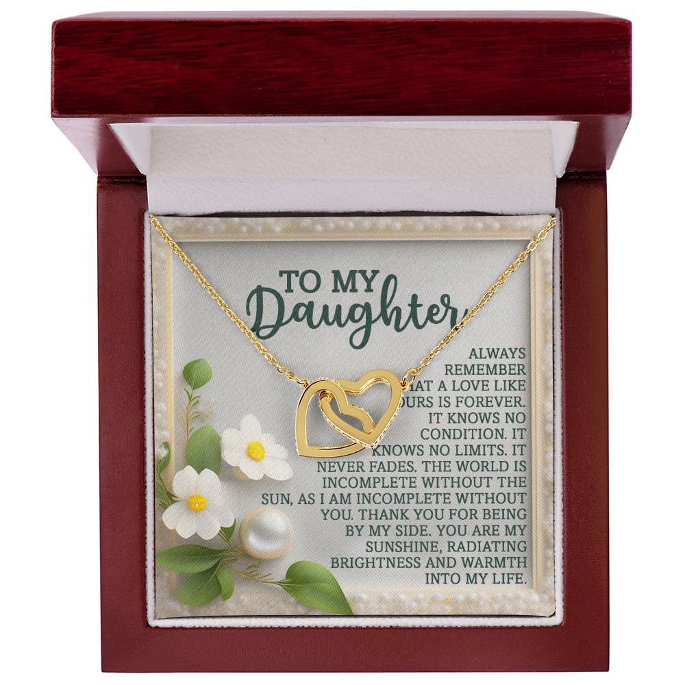 The Daughter-Love Forever - Interlocking Hearts Necklace, with a rose gold finish, is beautifully displayed in an open red jewelry box. The backdrop showcases a heartfelt message for a daughter, highlighted by white flowers and pearls to enhance the gift's sentiment.