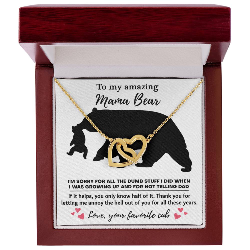 The "To Mom, Not Telling Dad - Interlocking Hearts Necklace," embellished with cubic zirconia crystals, comes in a jewelry box and is accompanied by a heartfelt message of gratitude and apology from "your favorite cub" to "Mama Bear.