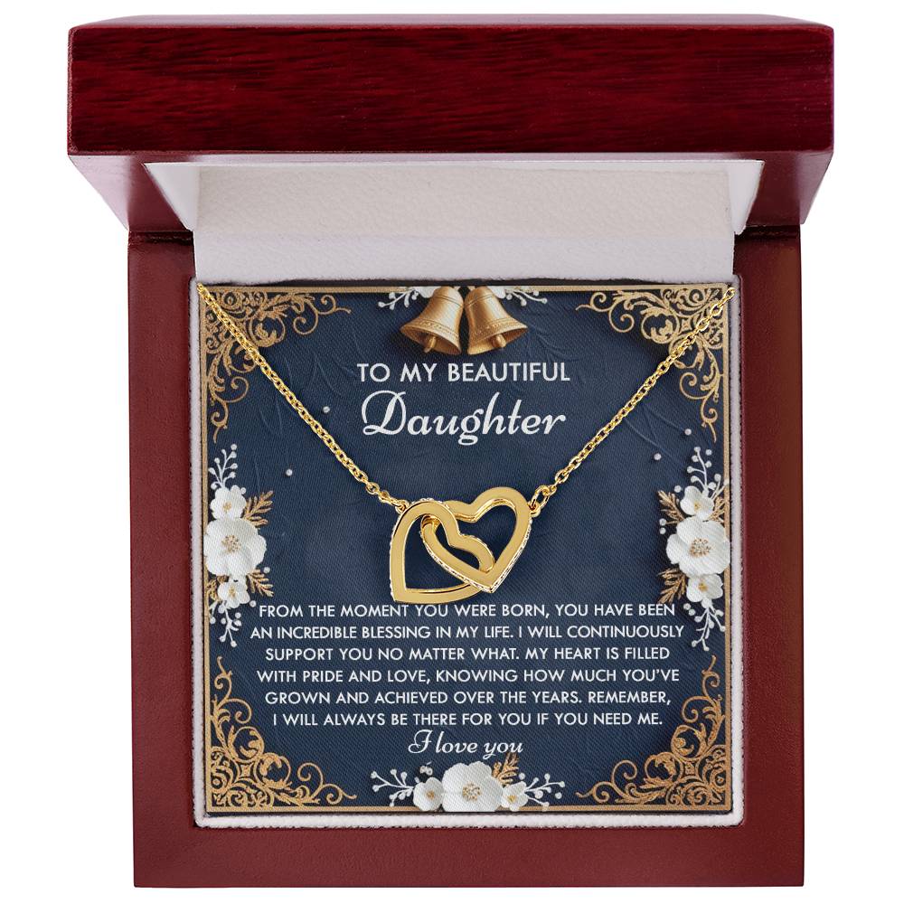 The Daughter-If You Interlocking Hearts Necklace features a rose gold finish, cubic zirconia crystals, and is nestled in a red gift box adorned with decorative flowers and bells, accompanied by a heartfelt message for your daughter.