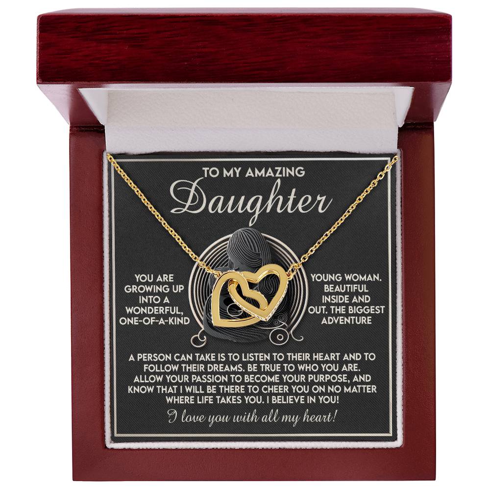 The Daughter-Your Dreams - Interlocking Hearts Necklace features shimmering cubic zirconia crystals, elegantly presented in an open red box. The inner lid is engraved with a heartfelt message of love and admiration for a daughter.