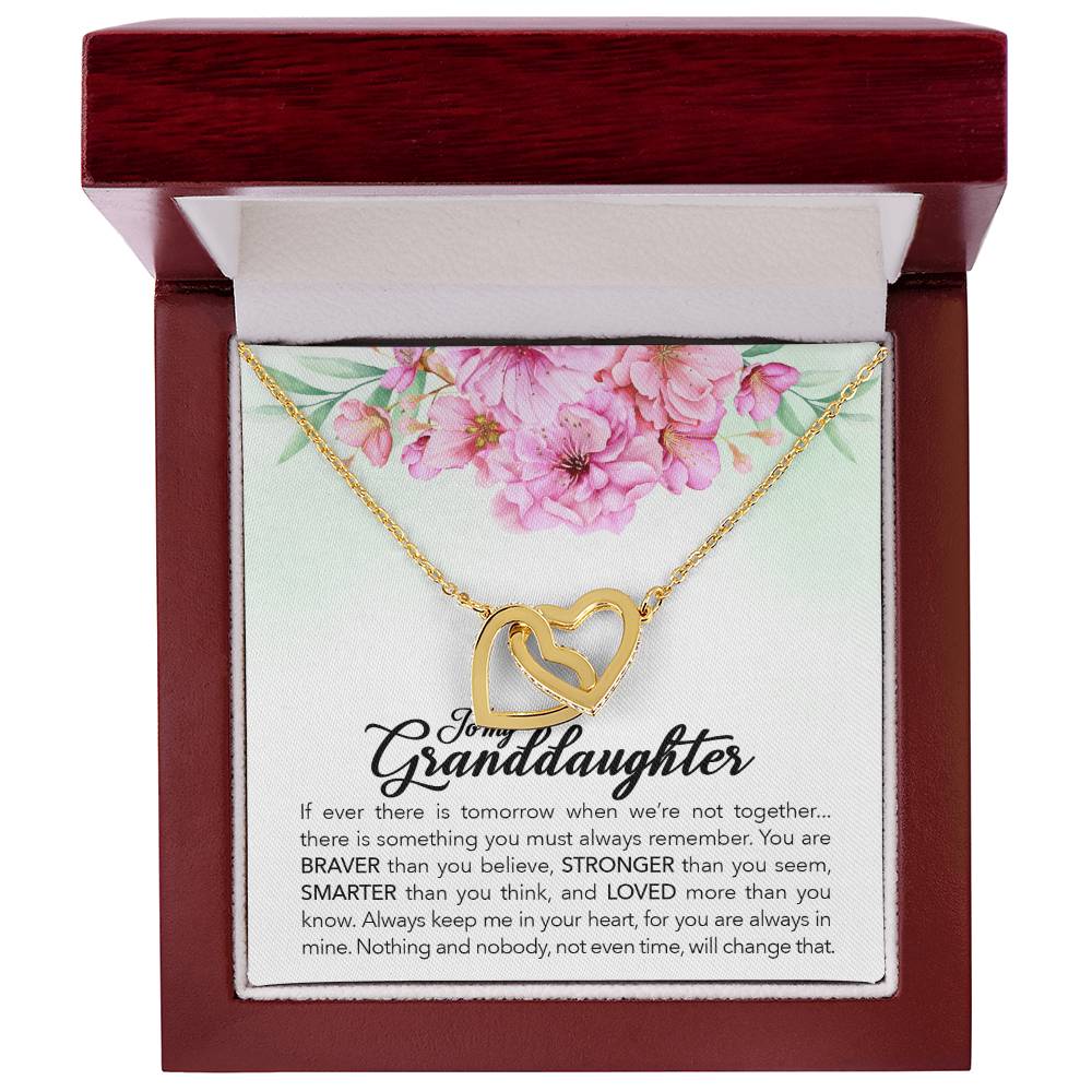 A heart-shaped pendant with an engraved message for a granddaughter, crafted from ShineOn Fulfillment's surgical steel jewelry, presented in a floral-themed gift box.