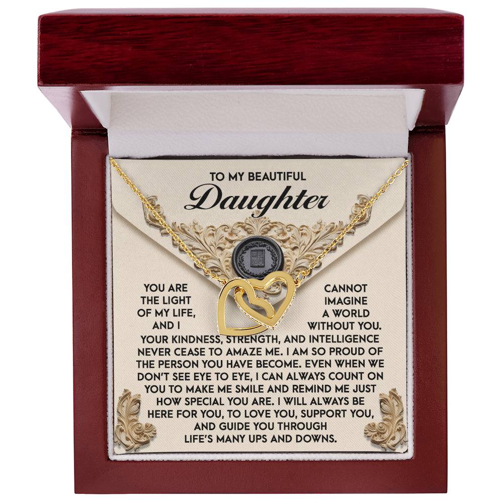The Daughter-Amaze Me Interlocking Hearts Necklace, presented in an open box with a heartfelt message to your daughter, dazzles with sparkling cubic zirconia crystals and a luxurious rose gold finish, perfectly symbolizing love's unbreakable bond.