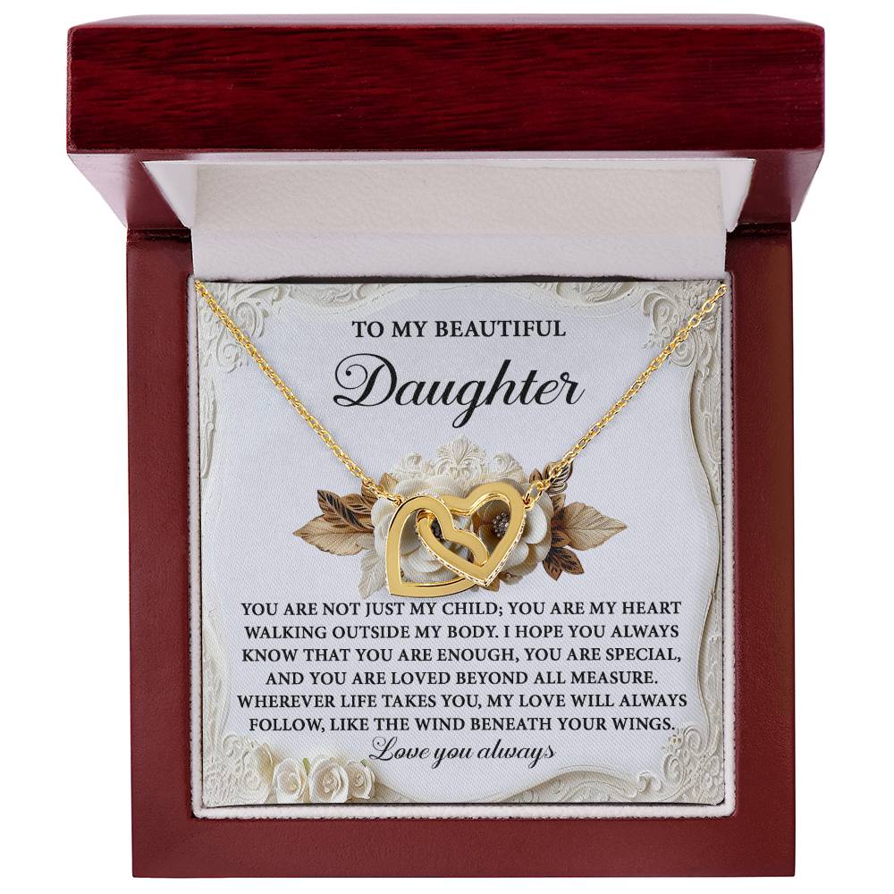 The Daughter-Beneath Your Wings - Interlocking Hearts Necklace, featuring sparkling cubic zirconia crystals and a rose gold finish, arrives in a wooden box with an affectionate message for your daughter, making it an unforgettable gift of love and connection.