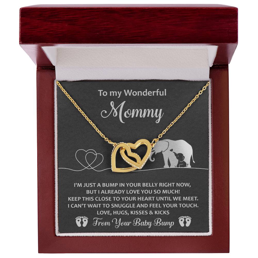 The "To Mama To Be, Until We Meet" necklace is an interlocking hearts design in gold, presented in a red box with an elephant detail and message from "Your Baby Bump." Adorned with cubic zirconia crystals, this unique gift shines with love and elegance for Mommy.