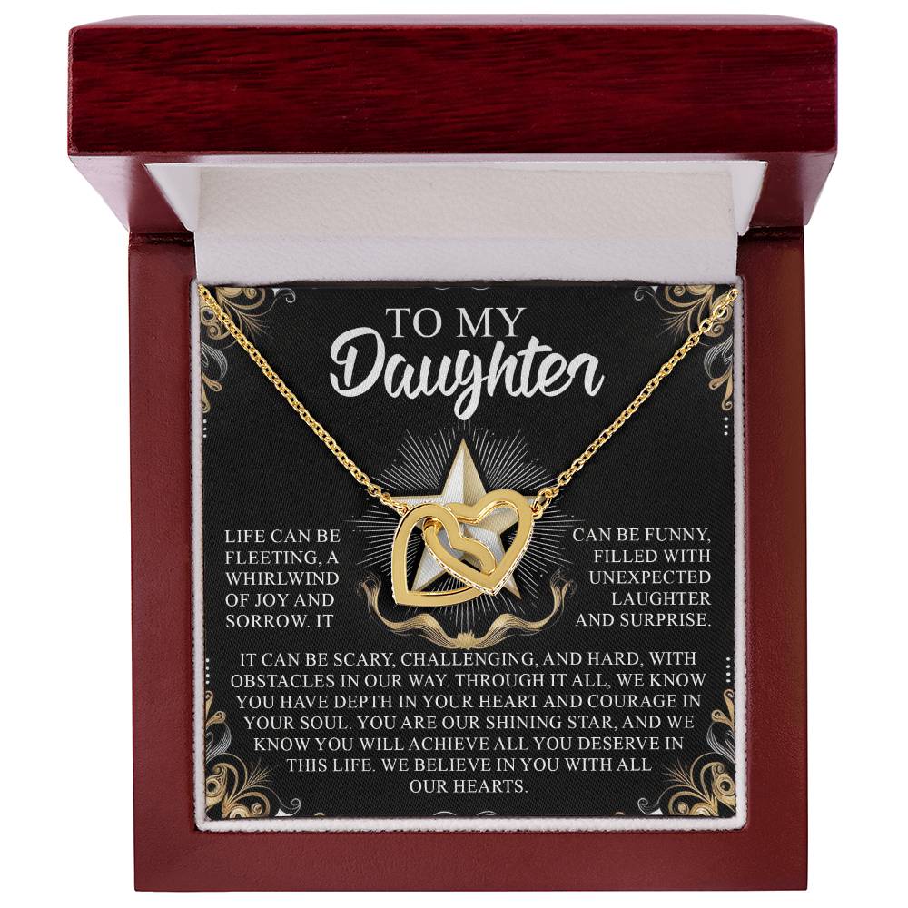 The Daughter-Shining Star Interlocking Hearts Necklace in rose gold features a dazzling design in a red box, with an inspirational message for a daughter about life's challenges, love, and support on the lid, adorned with gold floral designs and sparkling cubic zirconia crystals.