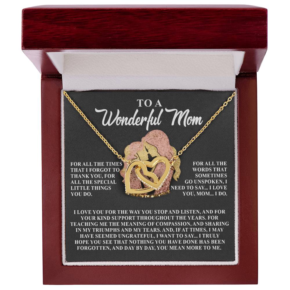 The Mom-More To Me - Interlocking Hearts Necklace features intertwined hearts with a mother-child figure adorned with cubic zirconia crystals in a rose gold finish jewelry box. The lid reads "To a Wonderful Mom," with a heartfelt message inside.