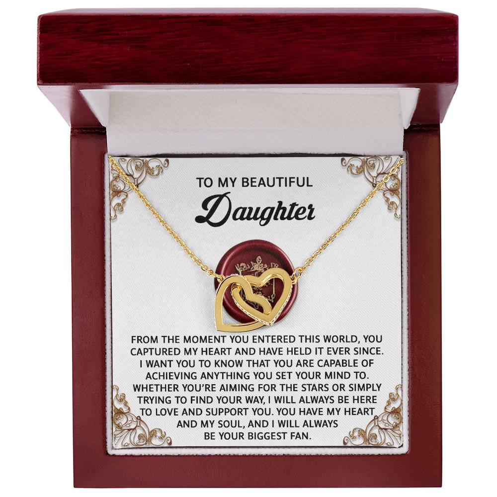 The Daughter-Biggest Fan - Interlocking Hearts Necklace, adorned with shimmering cubic zirconia crystals, is elegantly presented in an open box with a heartfelt message for your daughter. This exquisite gift beautifully symbolizes the unbreakable bond you share.