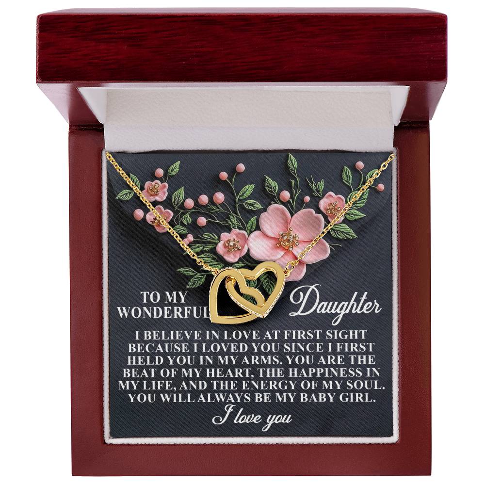 A jewelry box displays the Daughter-Love Sight - Interlocking Hearts Necklace in a rose gold finish. Pink flowers and a message expressing love and happiness to a daughter serve as the backdrop, ending with "I love you.