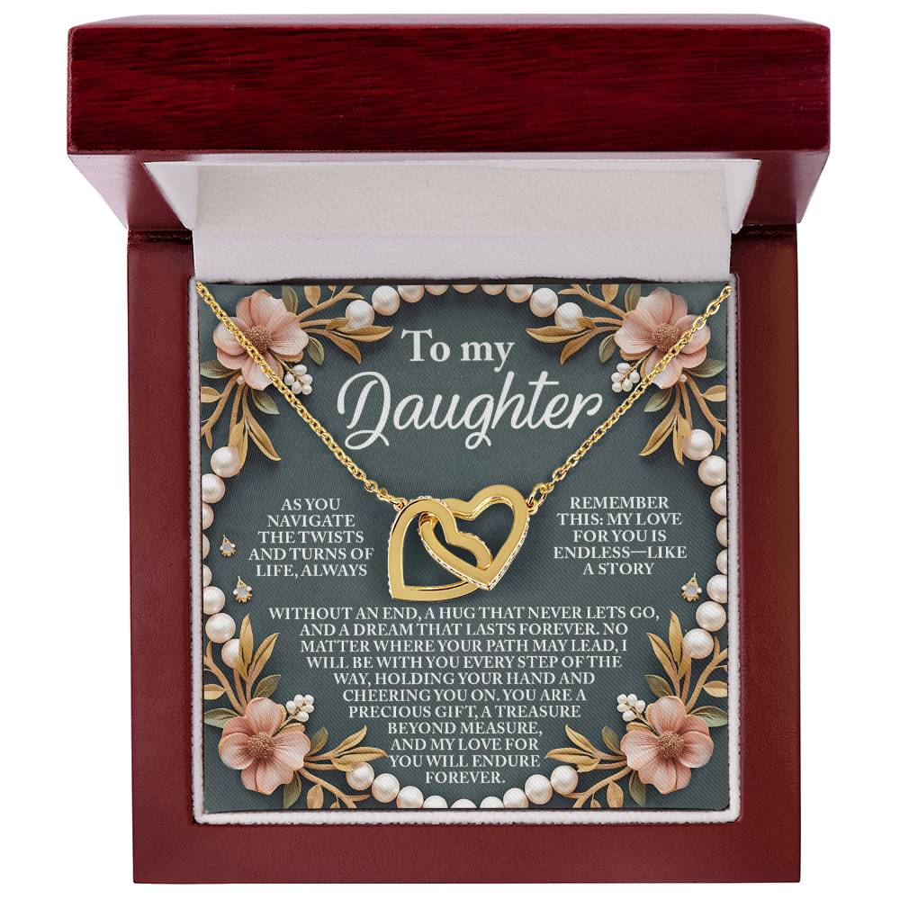 The Daughter-Endless Love - Interlocking Hearts Necklace, adorned with cubic zirconia crystals and a rose gold finish, comes in a red box with floral decorations and a heartfelt message to a daughter expressing endless love and support.
