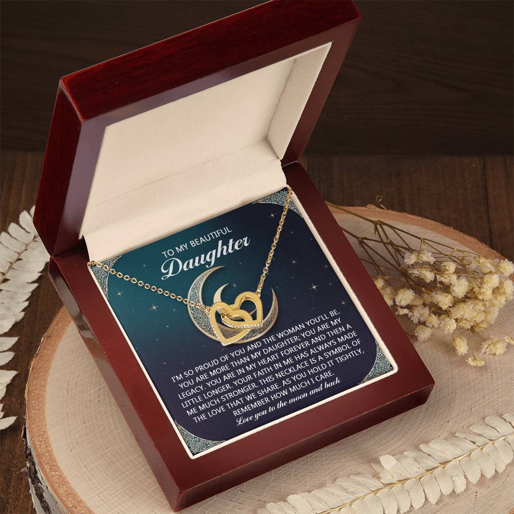 The Daughter-Hold It Tightly necklace features interlocking hearts and a heart-crescent moon pendant with rose gold elegance, adorned with cubic zirconia crystals and white flowers. The jewelry box lid delivers an uplifting message to a daughter, encouraging her to shine like the moon.