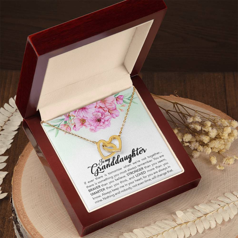 A "To My Granddaughter, Always Keep Me In Your Heart" interlocking hearts necklace by ShineOn Fulfillment, presented in a floral-themed gift box. This necklace is adorned with cubic zirconia, making it a perfect anniversary gift.