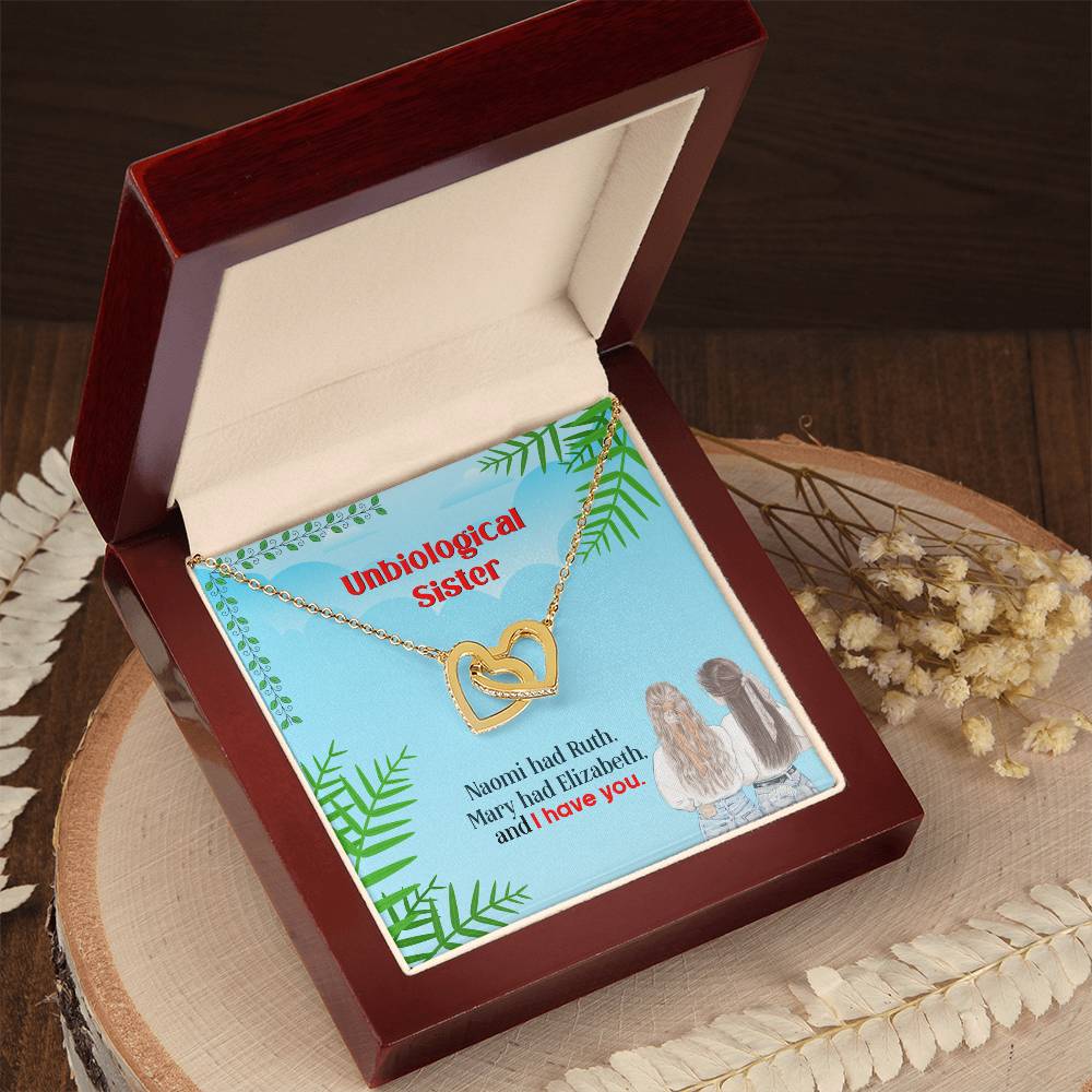 A To My Unbiological Sister, I Have You - Interlocking Hearts Necklace, adorned with cubic zirconia crystals and an angel charm, presented in a box with a message by ShineOn Fulfillment.