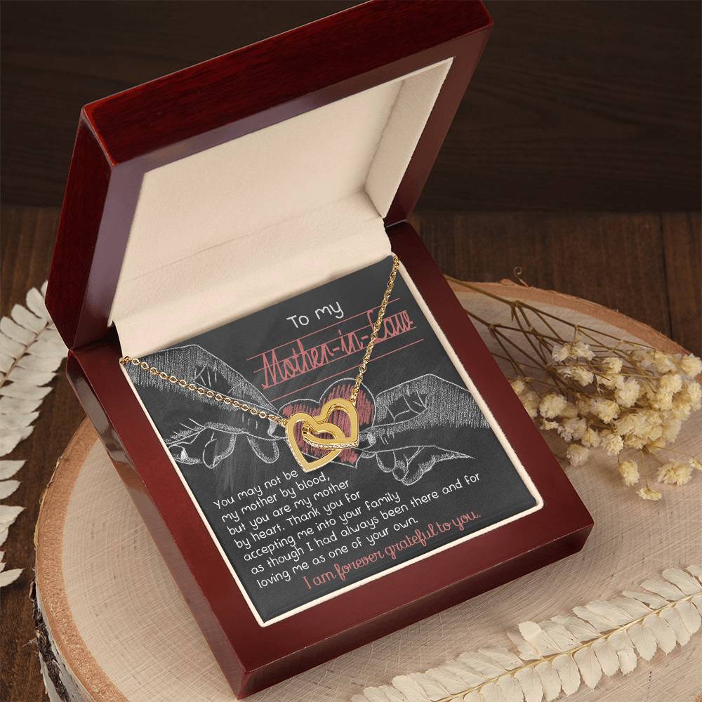 The "To Mother-In-Law, Mother By Heart" Interlocking Hearts Necklace makes a unique gift, adorned with cubic zirconia crystals and elegantly presented in a wooden box with a heartfelt message.