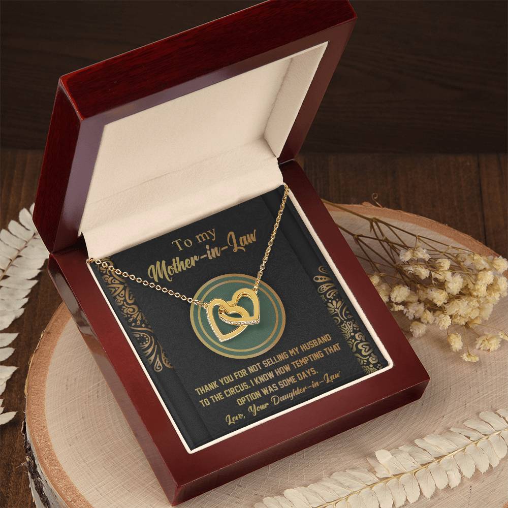 The "To Mother-In-Law, Thank You - Interlocking Hearts Necklace" is a gold piece adorned with cubic zirconia crystals. It comes in a red velvet box with a card reading: "To my Mother-in-Law. Thank you for not selling my husband to the circus. Love, Your Daughter-in-Law.