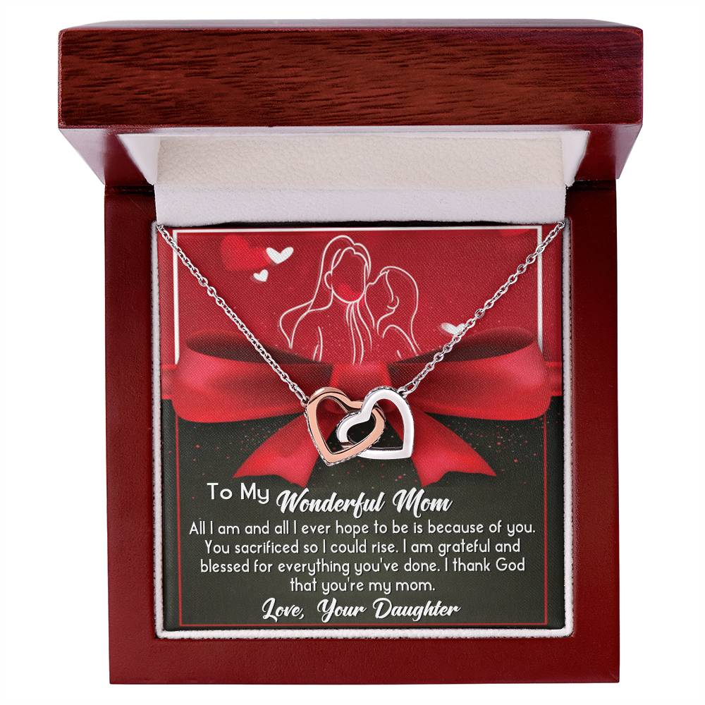 The "To Mom, Because Of You - Interlocking Hearts Necklace" features a rose gold finish and is presented in a wooden box. It includes a heartfelt note saying, "To My Wonderful Mom," and sparkles elegantly with cubic zirconia crystals from a daughter.