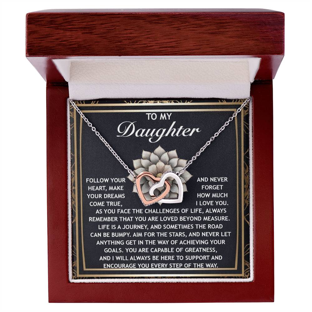 The Daughter-In The Way - Interlocking Hearts Necklace features shimmering cubic zirconia crystals and a rose gold finish, elegantly displayed in a gift box with an inspiring message encouraging your daughter to dream and feel supported.
